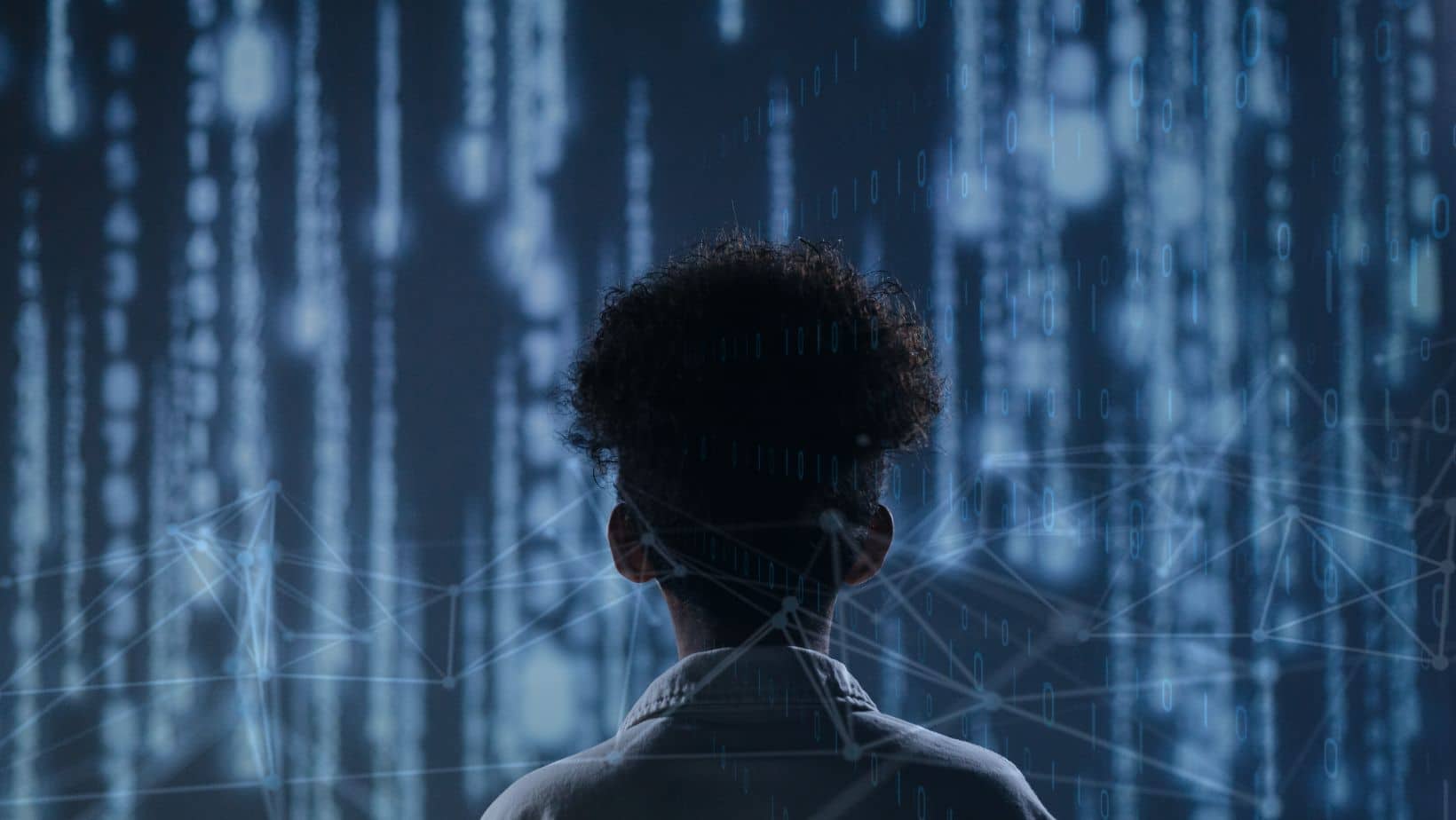 A person looking at a string of blurred computer code.